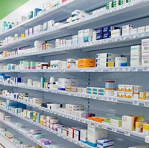 Shelves of medicine stocked and labelled at a pharmacy